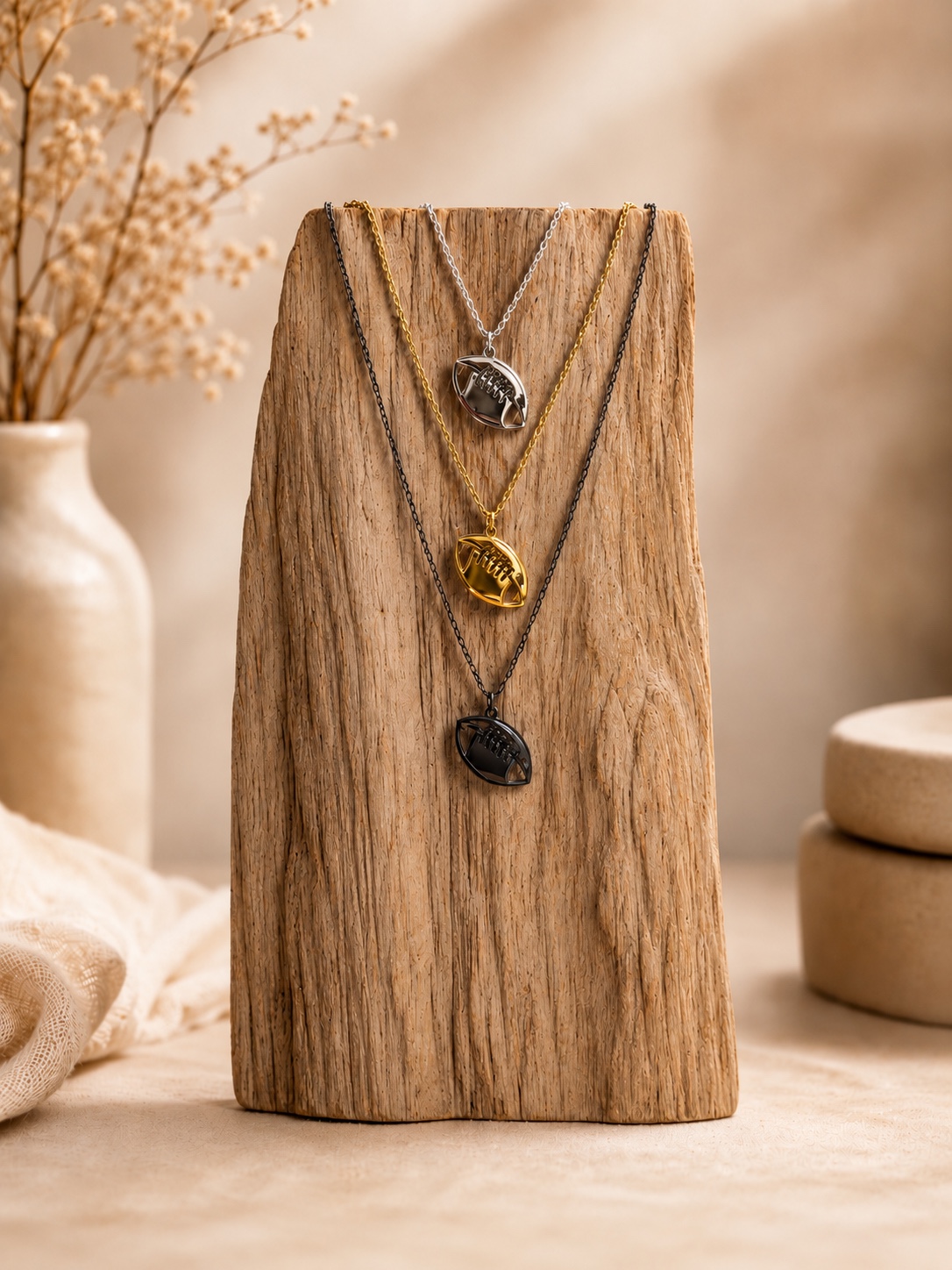 Football jewelry displayed on wood